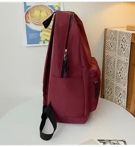 Seitenansicht eines burgunderroten minimalistischen Rucksacks mit großem Hauptfach