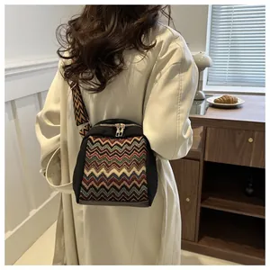 Close-up of ethnic style shoulder bag featuring zigzag woven pattern and wide strap