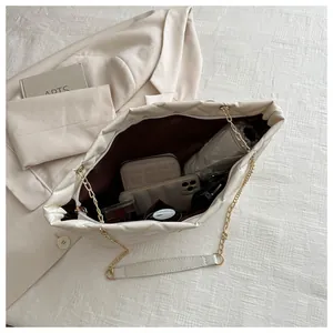 Detailed interior of a beige quilted tote bag showing large capacity for daily essentials