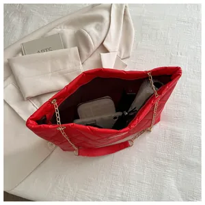 Internal view of red quilted tote bag showing large capacity for essentials