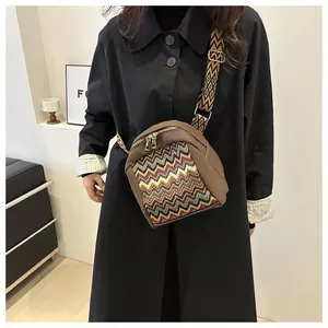Detail of bohemian crossbody bag with colorful zigzag embroidery and wide ethnic strap