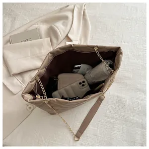 Top view of khaki quilted tote bag showing spacious interior with daily essentials