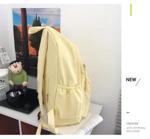 Detail of cream canvas backpack featuring drawstring side pocket and breathable mesh straps