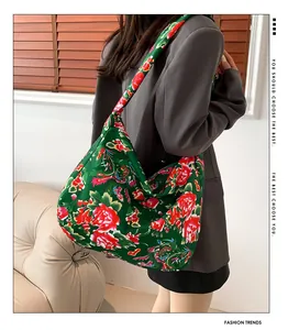 Detailed side view of large ethnic floral tote bag carried by a model in interior setting