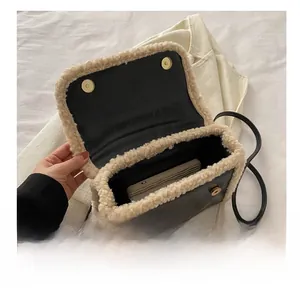 Detail showing the spacious interior of the faux leather bag with lamb wool trim