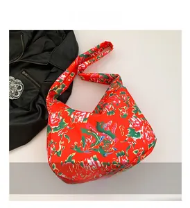 Detailed close-up of vibrant red floral pattern and fabric texture of the ethnic tote bag