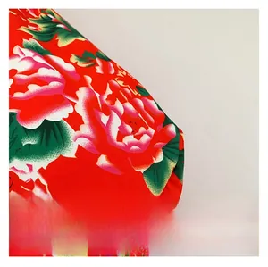 Macro shot of traditional Chinese ethnic red floral fabric with peony patterns and texture