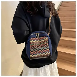 Deep blue crossbody bag with colorful wavy weave panel and wide ethnic shoulder strap
