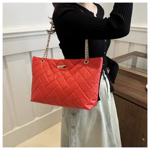 Chic red quilted tote bag with gold chain strap and elegant metallic hardware detail