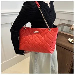 Large capacity red quilted tote bag with golden metal chain strap and v-shaped stitching