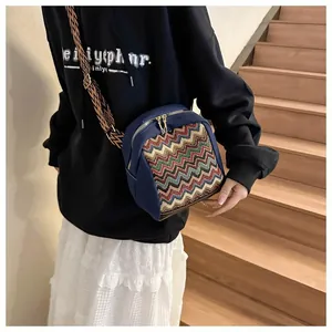 Ethnic wide strap crossbody bag with chevron pattern and golden zipper detail