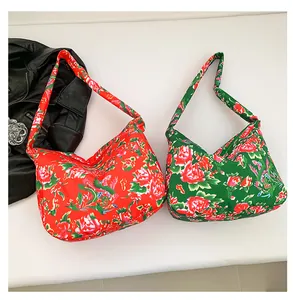 Detail of red and green Chinese peony pattern tote bags on a clean white surface
