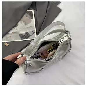 Silver dumpling bag interior showing capacity for phone, lipstick, and makeup