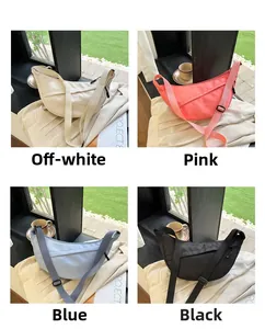 Detail of minimalist nylon crescent crossbody bag in off-white, pink, blue, and black