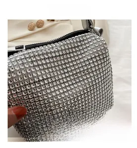 Macro shot of sparkling silver rhinestones and mesh pattern on luxury evening bag