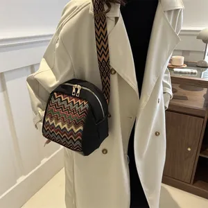 Ethnic style black canvas crossbody bag with colorful woven geometric patterns and wide strap