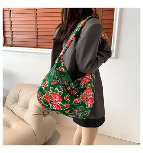 Back view of a model carrying a large ethnic floral tote bag with peony patterns