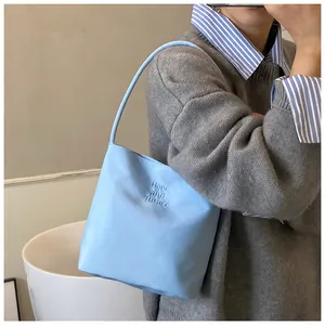Detail of light blue shoulder bag featuring Hope and Future embossed text design