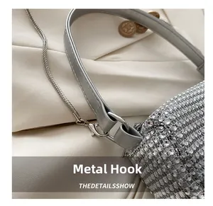 Detailed close-up of the silver metal swivel hook on a luxury rhinestone evening bag