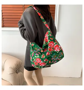 Detailed close-up of large floral hobo bag with traditional green and red peony pattern