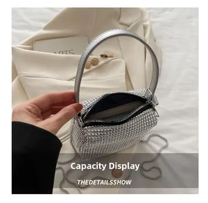 Detail display of silver rhinestone handbag showing inner capacity and chain strap