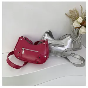 Detail of silver and magenta studded crescent bags with textured faux leather finish