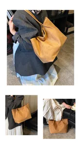Detail view of large brown suede tote bag featuring smooth texture and long shoulder straps