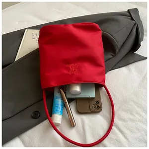 Red shoulder bag with Hope and future embroidery showing internal capacity and phone storage