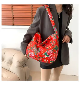 Detailed shot of ethnic floral tote bag with vibrant peony patterns and wide shoulder strap
