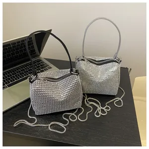 Detailed macro view of sparkling rhinestone handbag with silver metal chain and zipper