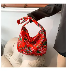 Detail of high-capacity tote bag with red traditional peony floral canvas fabric
