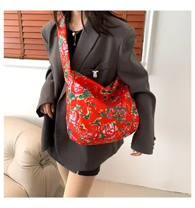 Close-up of traditional floral pattern on large canvas tote bag with wide strap