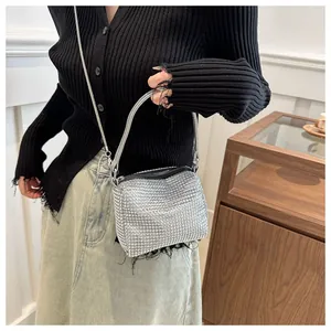 Detail of shimmering silver rhinestone evening bag with elegant chain strap and top handle