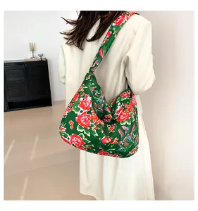 Detail of a large canvas tote bag with traditional Chinese green and red floral pattern