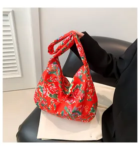Close-up of vibrant red peony floral tote bag featuring a knotted strap detail