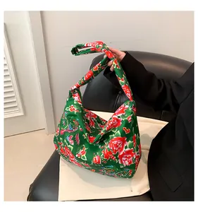 Detail of green floral tote bag with traditional Chinese peony and phoenix patterns