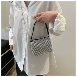 Detailed close-up of sparkling silver rhinestone evening bag with elegant chain strap