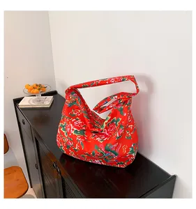Detail of a large ethnic floral tote bag on a wooden cabinet in a minimalist room