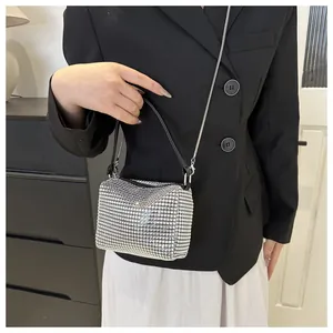 Detailed close-up of a silver rhinestone mini evening bag with metal chain strap
