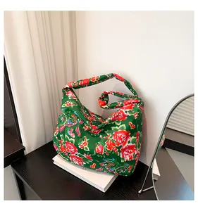 Detail of green floral tote bag with traditional Chinese peony and phoenix patterns
