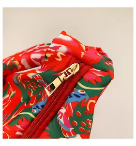 Detail of colorful ethnic floral fabric with premium gold metal zipper on tote bag