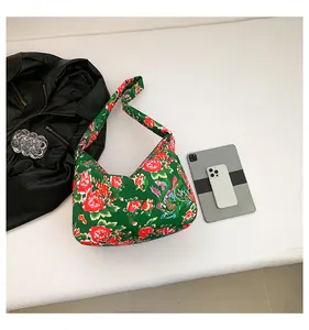 Spacious tote bag with traditional floral print next to a tablet for size reference