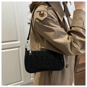 Fashionable leopard print baguette bag on a khaki trench coat for trendy street style