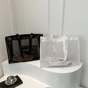 Bolsos de malla minimalistas en blanco y negro con gran capacidad y asas de cinta tejida