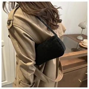 Chic black leopard print underarm bag with suede texture styled on a trench coat