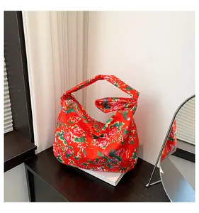Detailed view of large capacity tote bag with traditional Chinese red floral silk pattern