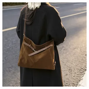 Brown faux suede tote bag shown on model shoulder for retro and casual daily outfit look