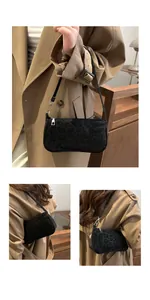 Close-up of black leopard print texture and silver zipper on chic baguette shoulder bag