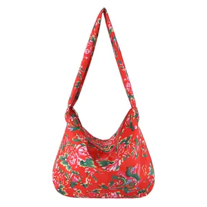 Ethnic style shoulder tote bag with red peony floral pattern on a white background