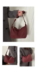 Macro detail of wine red leopard embossed tote with gold metal zipper and nylon texture